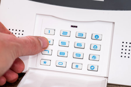 Man's Finger Entering Code In Security Home System