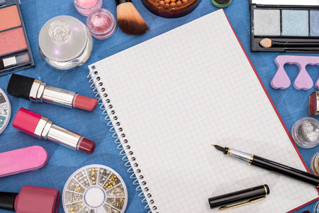 Decorative cosmetic set - palette, brush, eye shadow, powder, lipstick with empty notepad.の写真素材