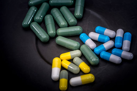 Medicine pills or capsules on plate on wooden desk with copy space.