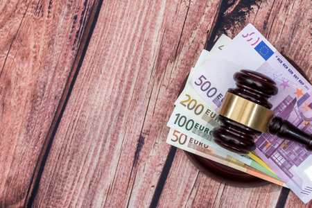 gavel and euros money on wooden table. close up.の写真素材