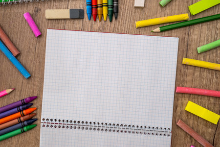 empty notepad with color chalks and pencils on desk.の写真素材