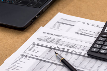 Document - Personal Budget with a laptop, a calculator and a river on the table.の写真素材