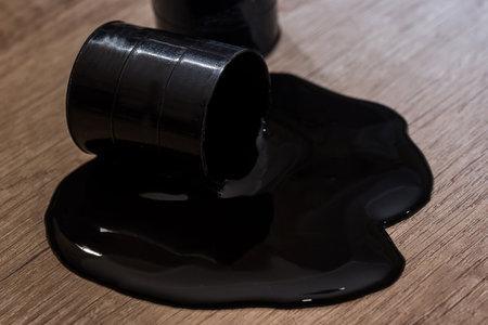 two fuel drums with spilled oil on desk.の写真素材