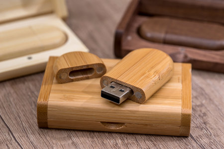 Wooden flash drive on wooden table.