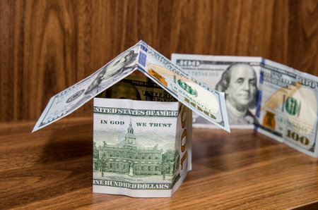 new dollar house, money building, isolated on wooden backgroundの写真素材