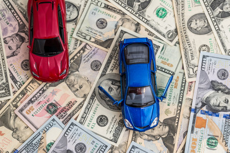 red and blue cars with dollarの写真素材
