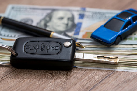 car key with pen and dollarの写真素材