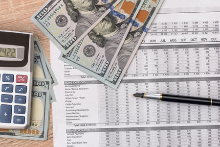 analysis of the annual budget with calculator and money on the table. financial concept.の写真素材
