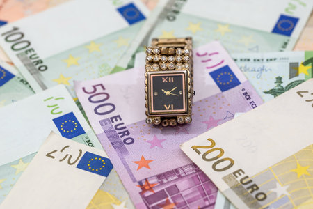gold woman clock on euros bills. close up.