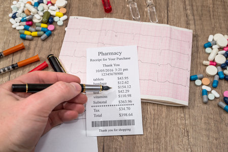 man showing on pharmacy receipt with rx blank, pills, syringe on desk.