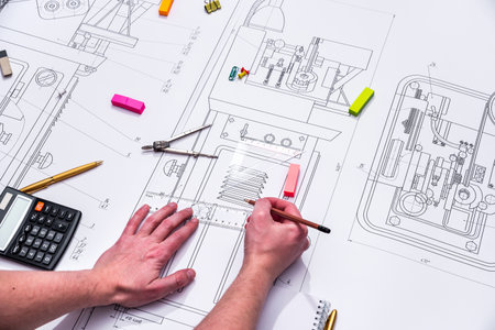 technical drawing and tools in hand