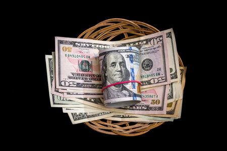 Basket with dollar isolated on blackの写真素材