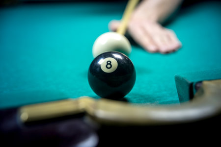 man playing billiards in dark club