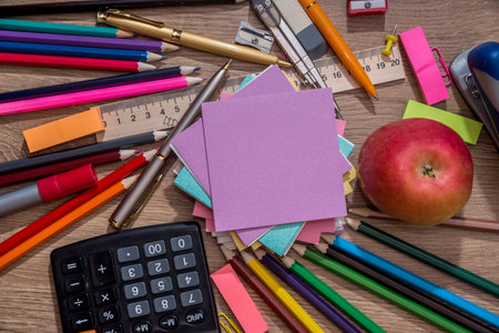 various school items on wooden background