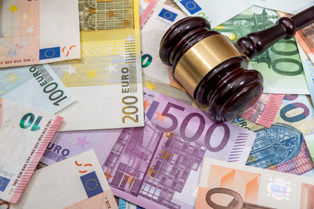 hammer on euro coin and bills.