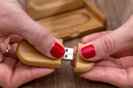 Hands opening wood USB Flash Drive