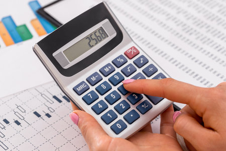 Woman calculate about expenses at office.