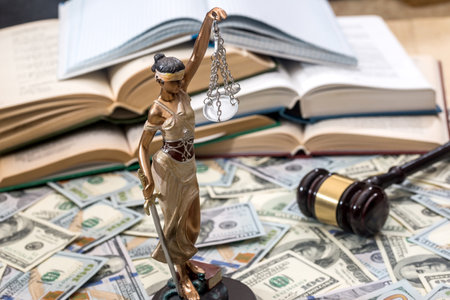 Lady justice or themis, book and gavel on dollar bills
