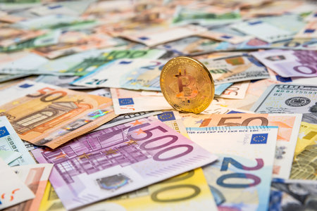 Bitcoin on dollar and euro banknotesの写真素材