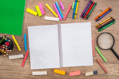 School Supplies - notepad and color pencils on a wooden background and place for text.の写真素材