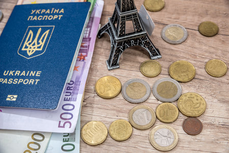travel concept - eiffel tower, passport, euro money on desk.