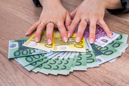 Woman holding 100 200 500 euro bills. money concept.の写真素材