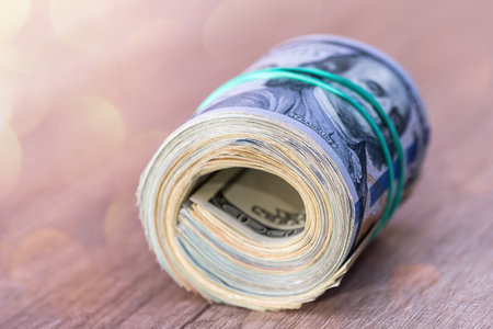 us dollar roll on a wooden tableの写真素材