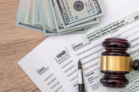 1040 tax form with gavel and dollars and pen.の写真素材