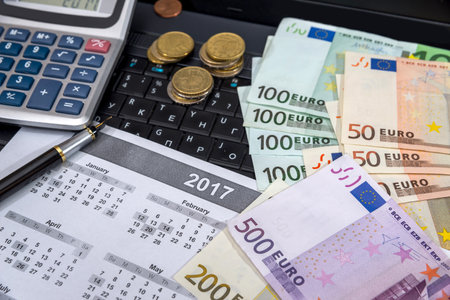 laptop, calendar and euro bills.の写真素材