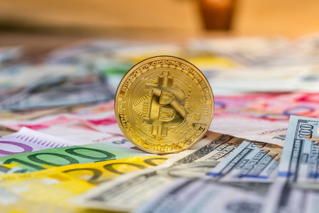 yen, yuan, euro and dollar banknotes with bitcoinの写真素材