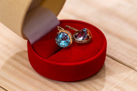 Gold earrings with crystal in a gift boxの写真素材
