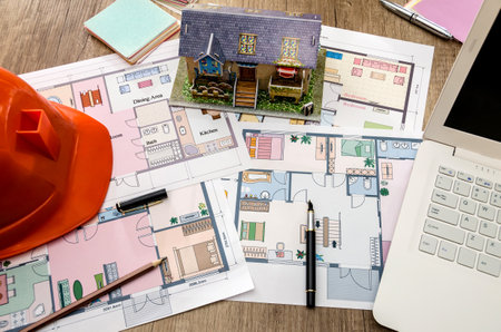 drawing of a building with a model and a laptop