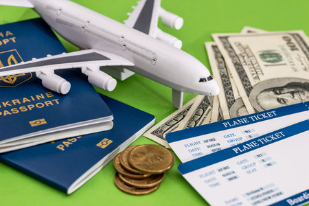 Airplane, passport, ticket and dollar on greenの写真素材