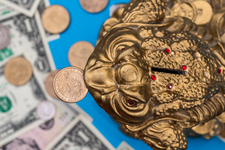 Symbol toad and dollar coin and banknote isolated on blue