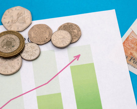 british money - banknote and coin on business graph