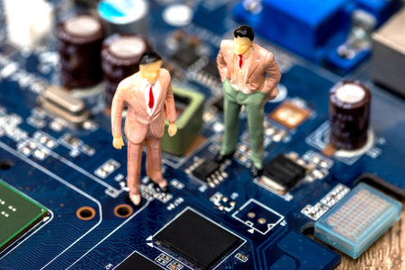 miniature people are on the motherboardの写真素材