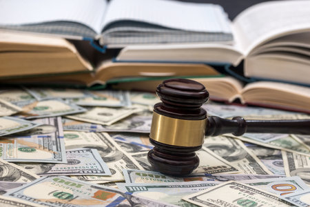 wooden gavel on us dollar banknoteの写真素材