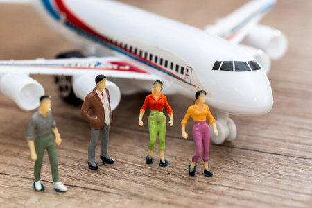 Miniature people go to airplane - travel conceptの写真素材