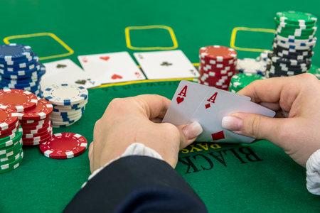 Woman looking gambling poker card in casino