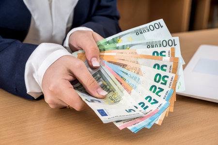 Close-up of business lady that deducts euro, and calculatorの写真素材