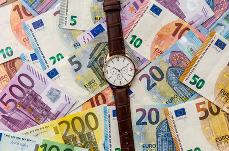 Clock on euro banknotes. close up.の写真素材