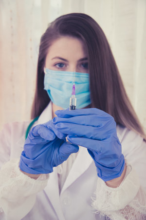 Beautiful nurse ready for injection, syringe with medicamentの写真素材