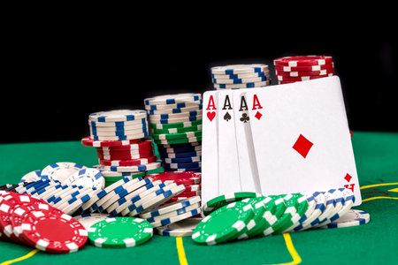 playing cards and casino poker chips on green