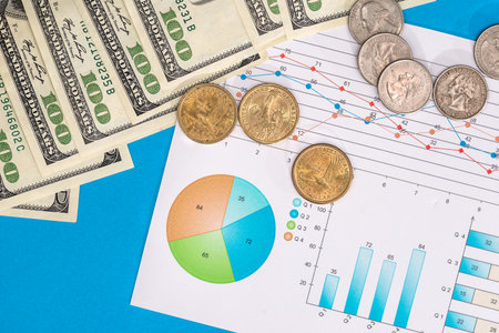 Business graph with dollar bills and coinの写真素材