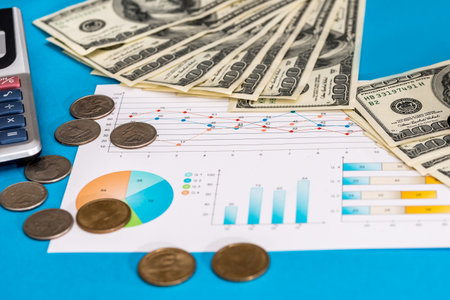 Business graph with dollar bills and coin