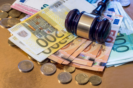 hammer with many euro bills and coinの写真素材