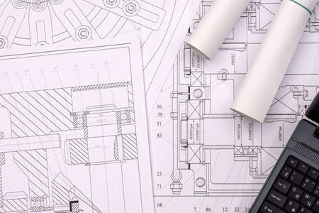 Engineering drawings of parts with a laptopの写真素材