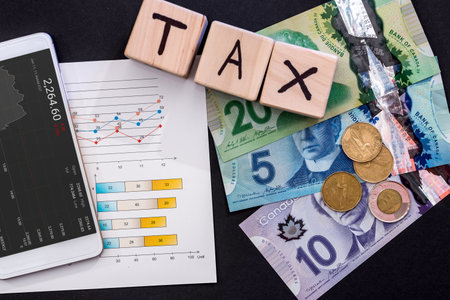 Taxation concept with canadian dollar, business graph and phoneの写真素材