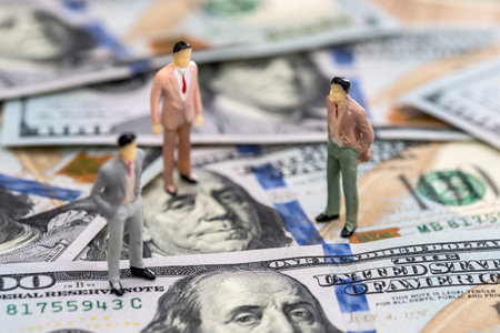 Small toy people on dollar banknotes close upの写真素材