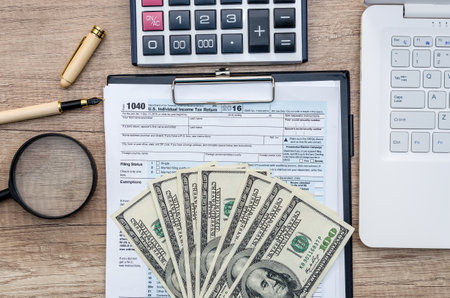Tax 1040 form with money and calculator